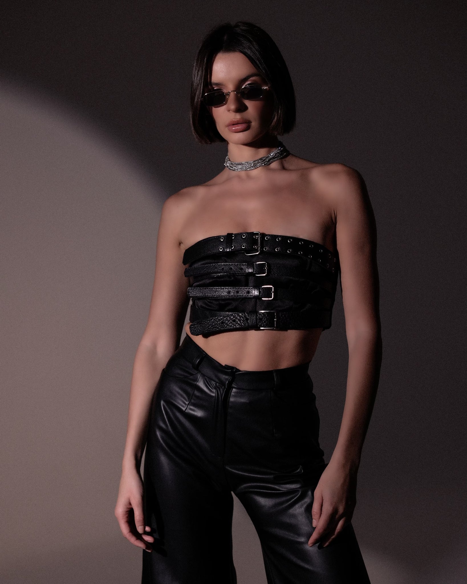 Belts cropped top & Leather Flair Black Pants.